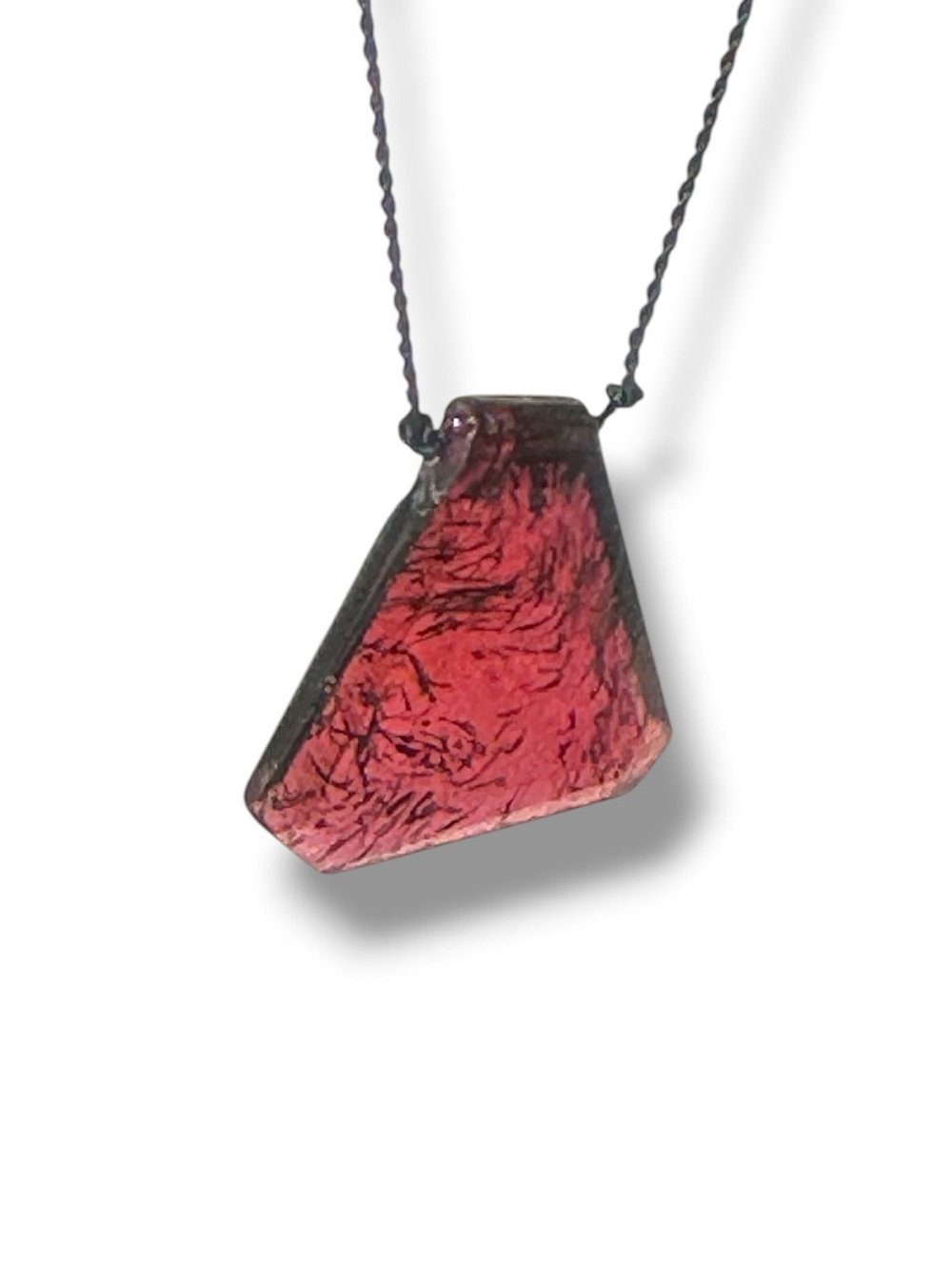 trapezoid-cut natural garnet slice suspended from a minimalist dark silk cord